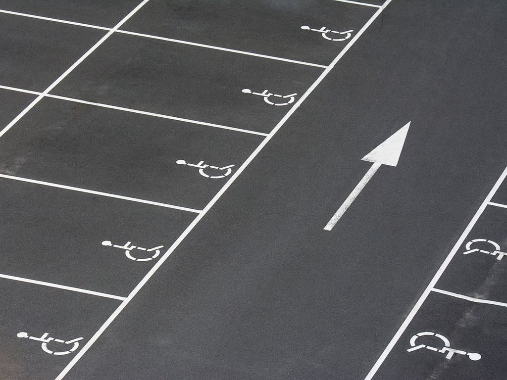Parking lot with accessible parking spaces and directional arrow