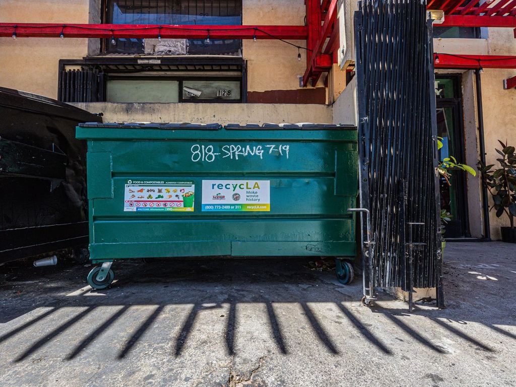 Commercial dumpster outside a building
