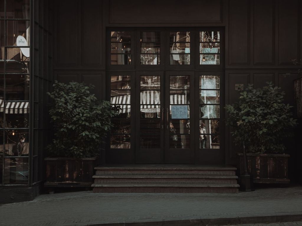 Commercial building entrance with glass doors and planters